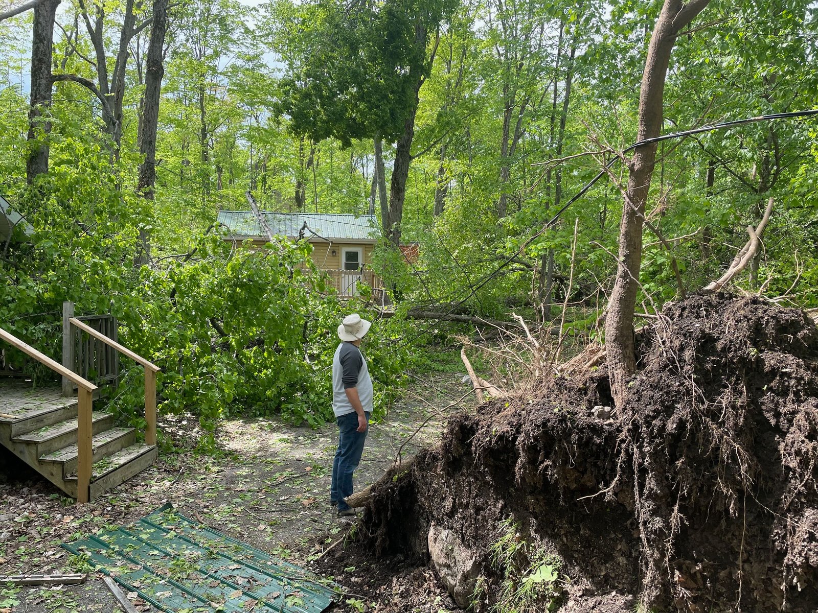 A camp, damaged by a derecho storm that knocked down trees and power lines, recovers thanks to families who volunteer to help clean up.