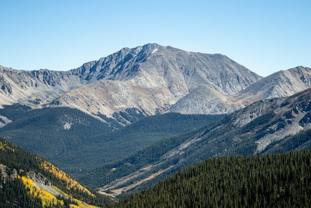 Majestic mountain range under a clear blue sky.